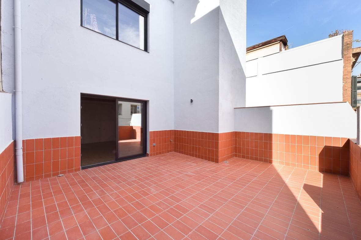 Esquina de la terraza, con la carpintería corredera y los paramentos recién pintados